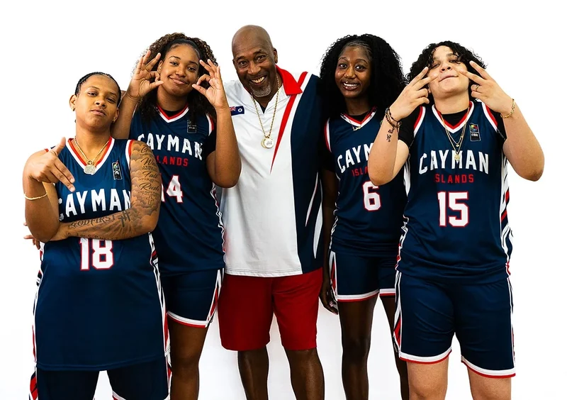 Cory McGee with Cayman Islands basketball players in national team jerseys, N' Between Dreams Breakfast Club student-athletes